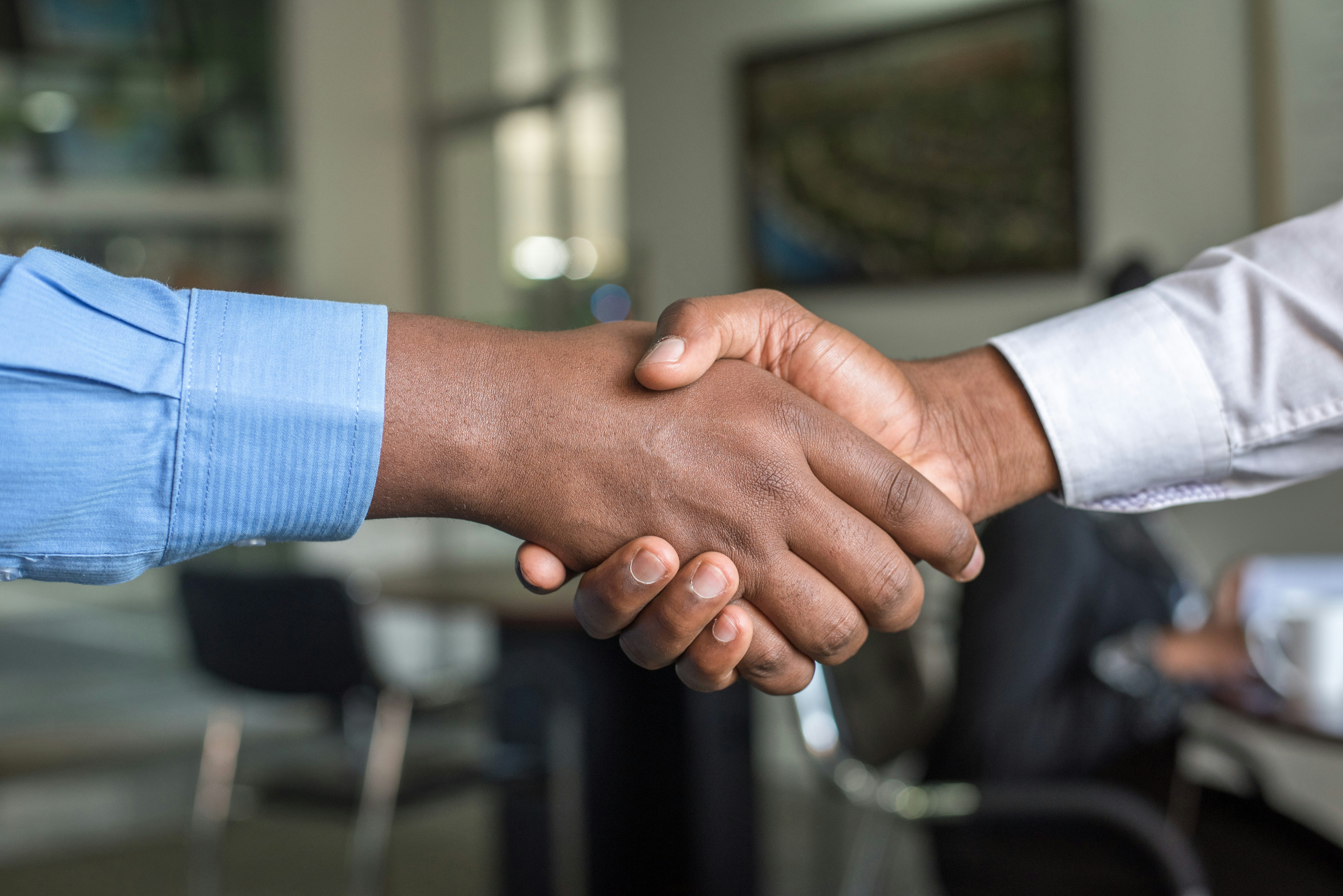 Professional handshake representing partnership in relocation services